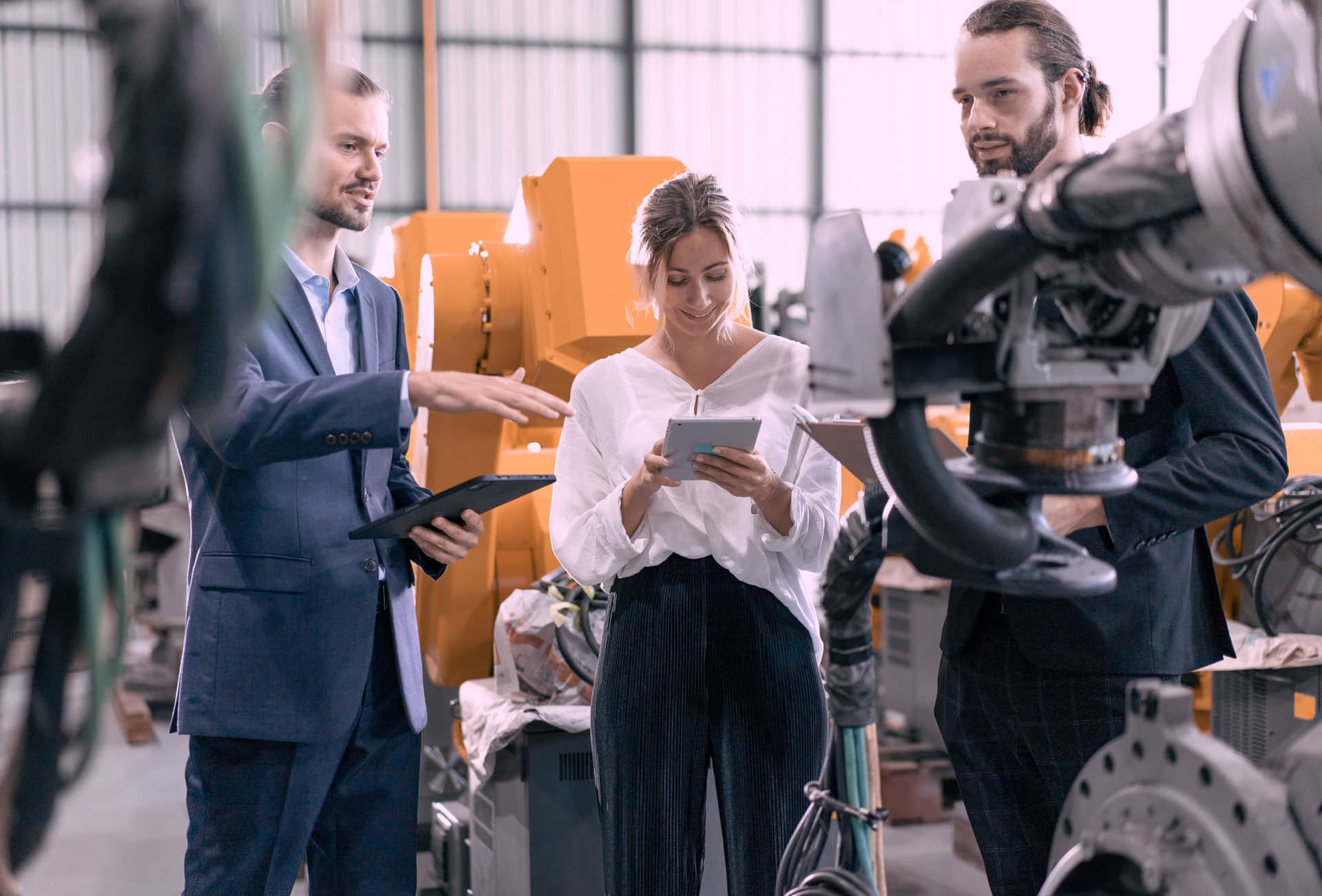 Learning expedition visit with a man presenting his factory to two visitors.